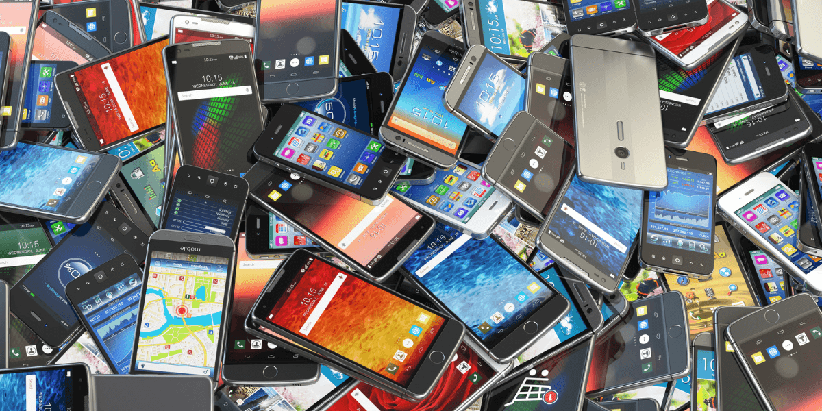 A chaotic pile of smartphones displaying various colorful screens and apps.