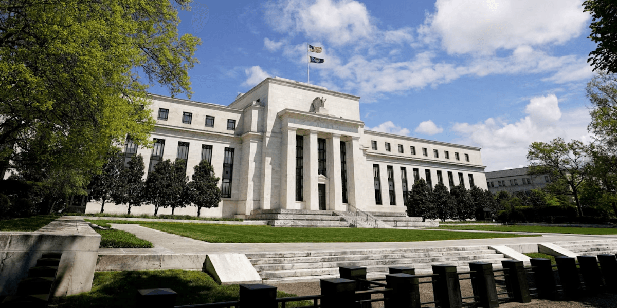 Exterior view of the Federal Reserve building with flag and trees in foreground