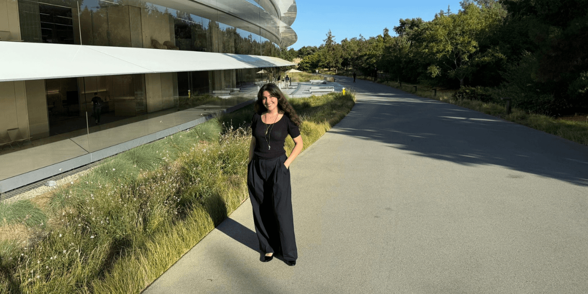 "Anna Belhassen standing outside a modern building, representing her work in adaptive sports technology and engineering innovation."