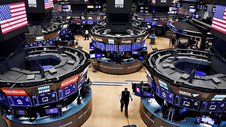 View of the New York Stock Exchange trading floor with multiple screens and traders