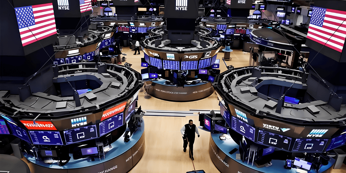 View of the New York Stock Exchange trading floor with multiple screens and traders
