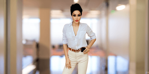 The image features Dr. Fia Johansson in a professional white shirt and beige pants, standing confidently in a modern office.