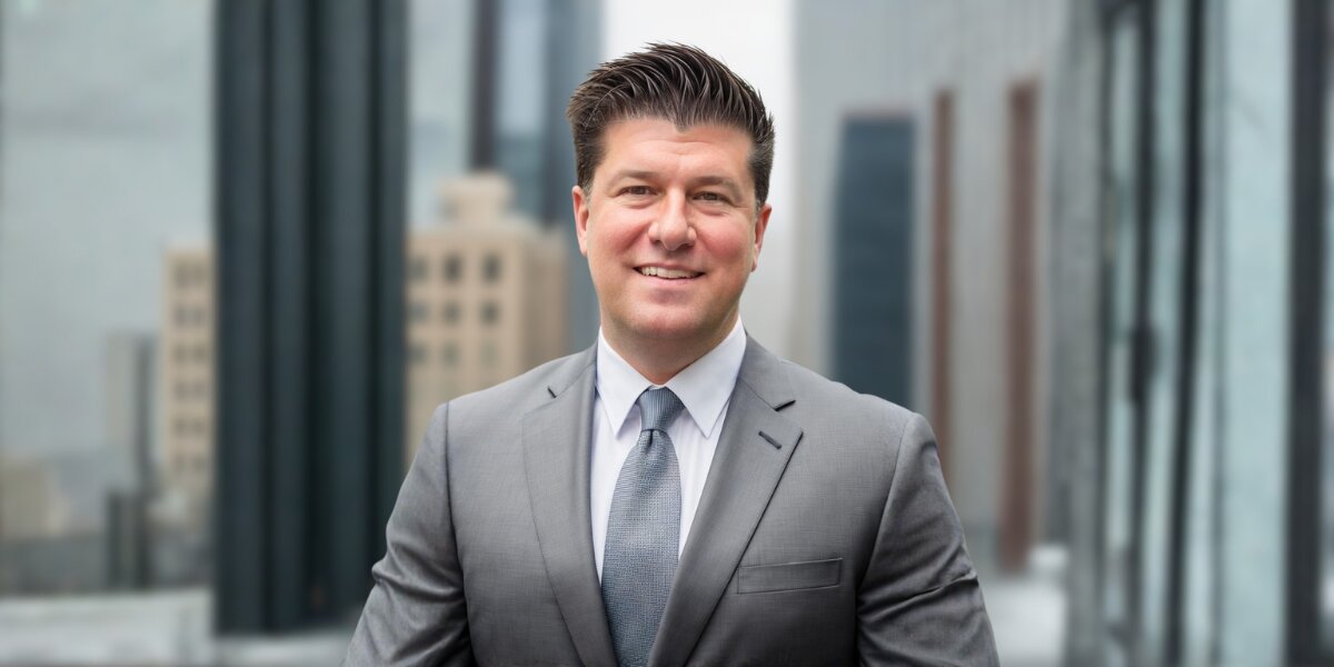 Scott DeSalvo, an award-winning personal injury lawyer in Chicago, confidently stands outside a building, exemplifying professionalism and dedication.