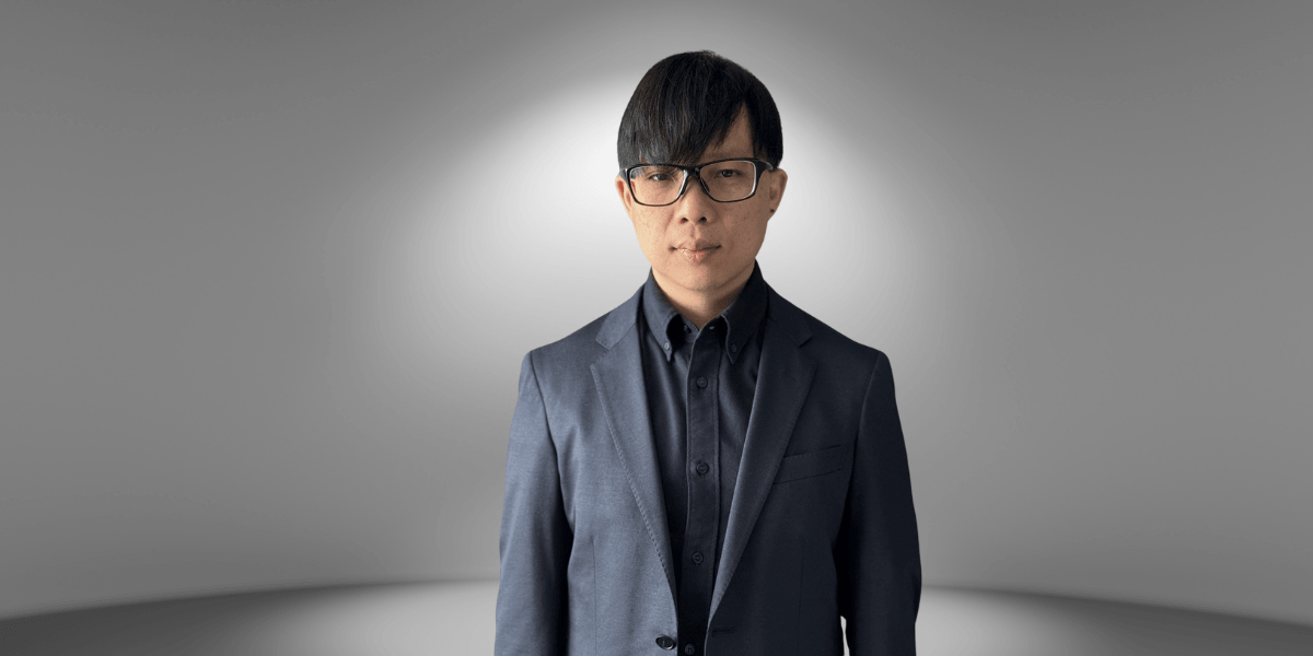 Ivan Yong posing professionally in a suit, representing his leadership expertise and global influence.