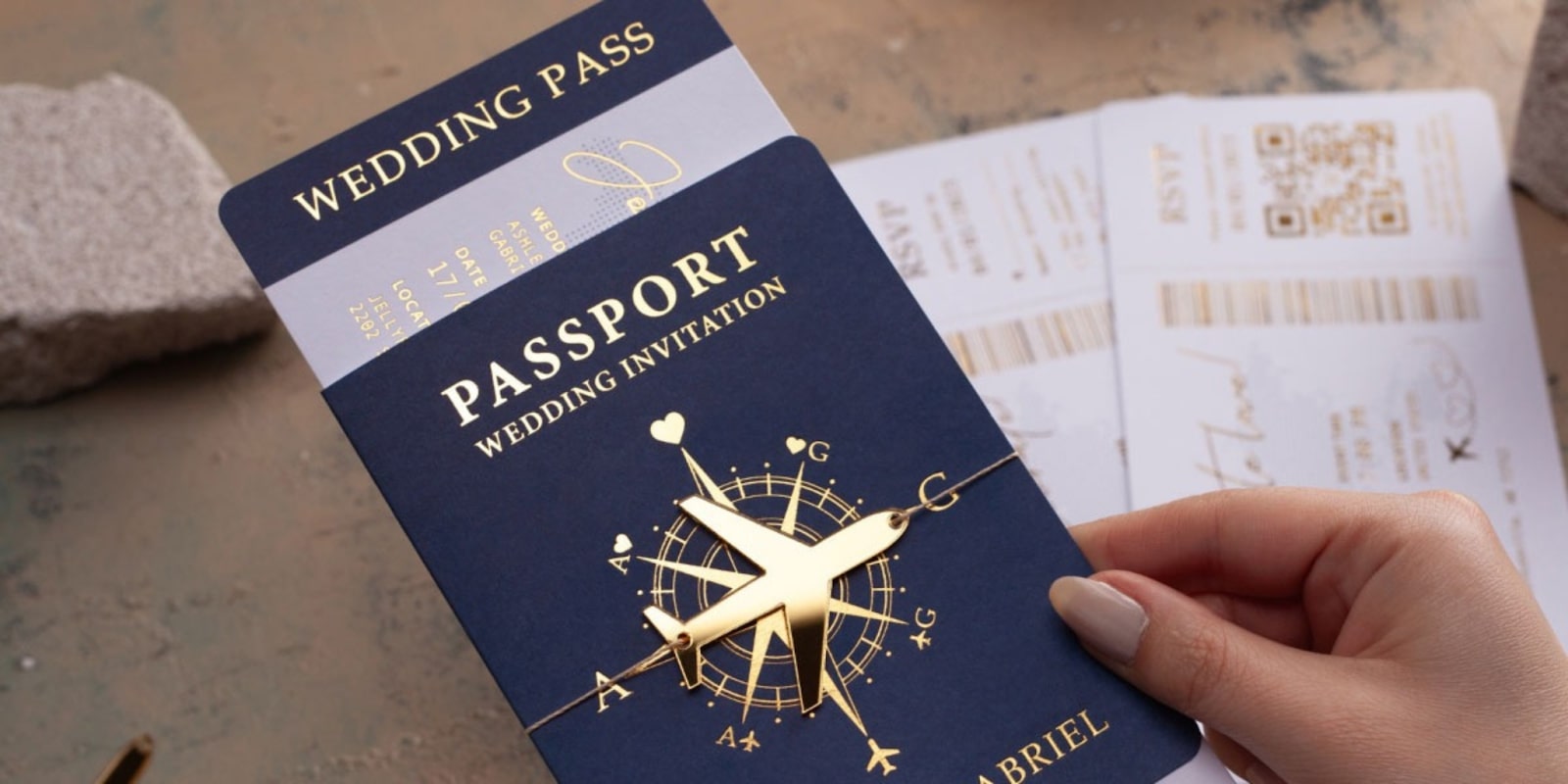 Luxury wedding invitation designed as a passport with gold accents, featuring modern typography and an airplane graphic.