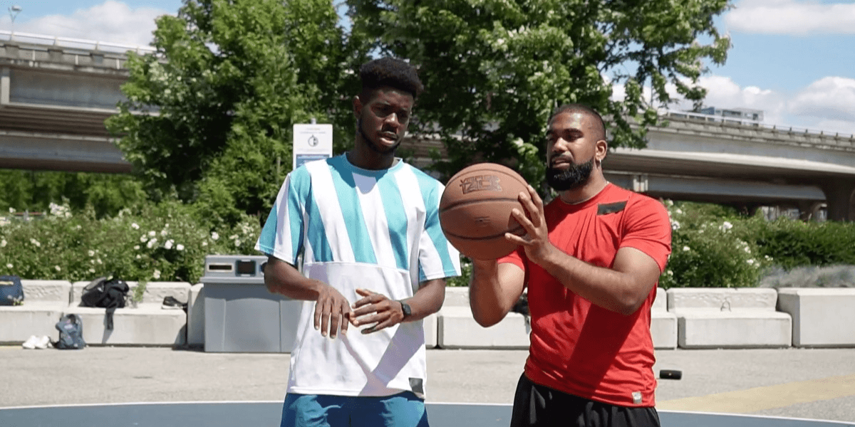 Two individuals practicing basketball outdoors, representing Training Booker’s emphasis on hands-on learning, real-time guidance, and skill-building.