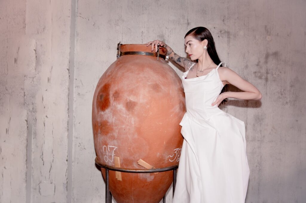 Model, Victoria poses in the White Rose Gown moments before the debut runway. Captured by Juniper K.