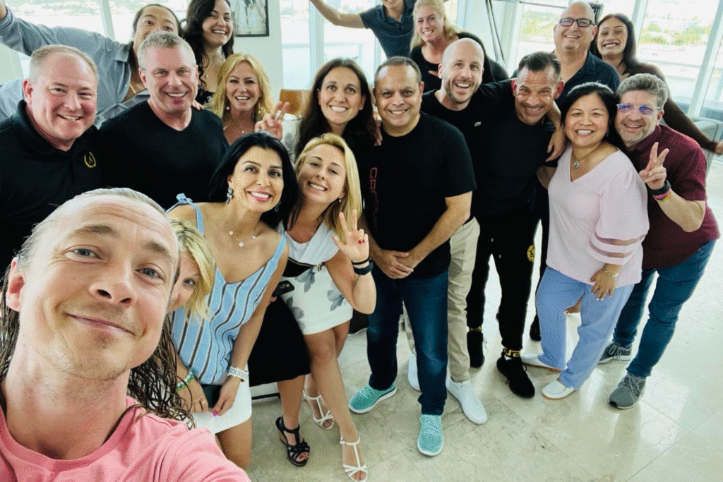 A large group of people gathered for a photo, smiling and posing together in a casual setting.