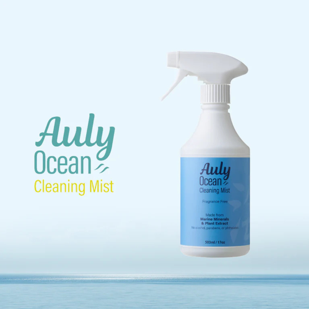 Auly Ocean Cleaning Mist fragrance-free spray bottle made from marine minerals and plant extracts, positioned with a serene ocean background, emphasizing its eco-friendly and natural cleaning properties.