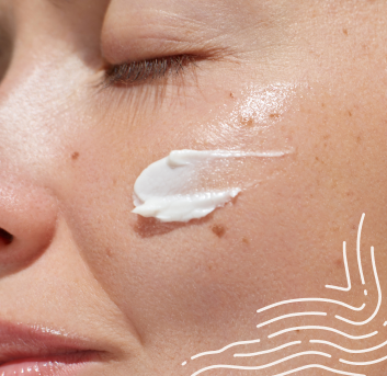 "Close-up image of a person applying skincare cream to their face, focusing on smooth and hydrated skin for a healthy glow."