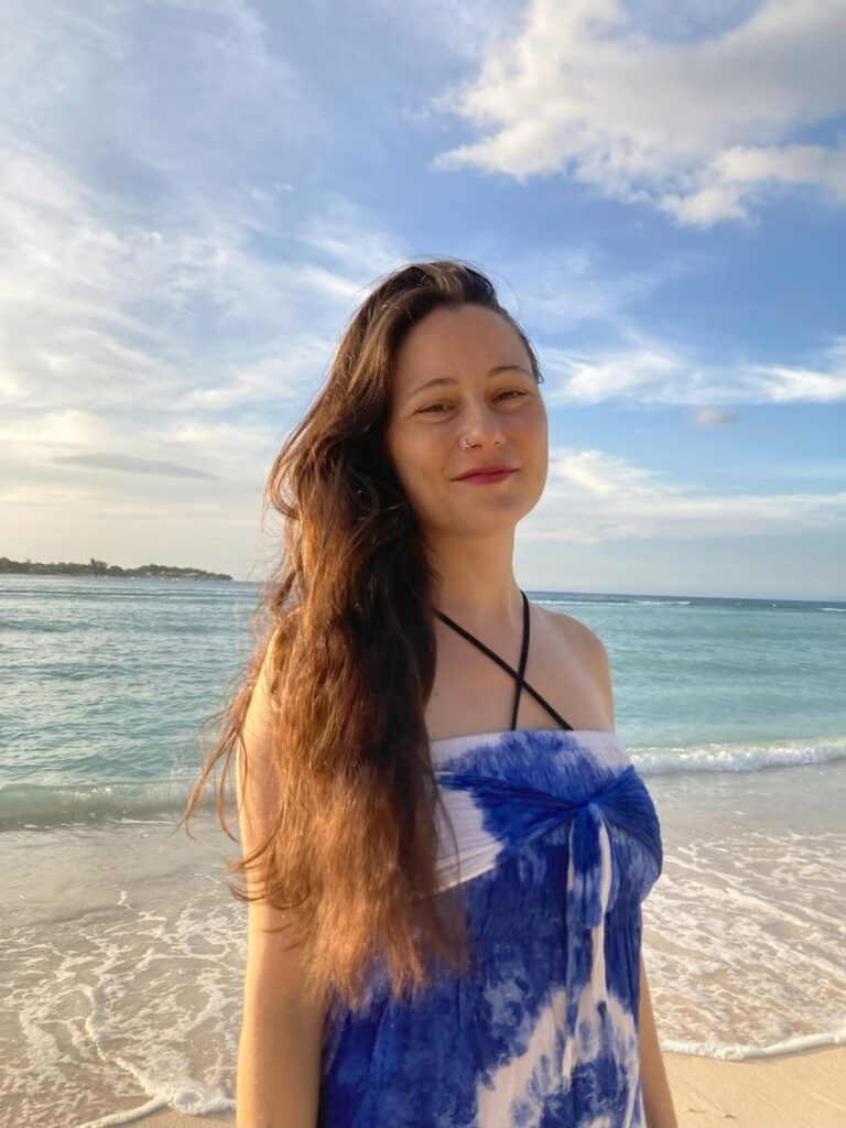 Carla Janse Van Rensburg on the beach: Carla Janse Van Rensburg, spiritual guide, in Bali’s serene landscape, embodying healing energy.