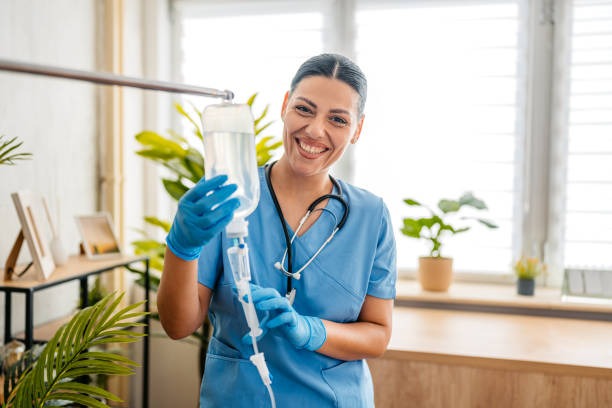 Nurse holding an IV bag, ready to administer hydration therapy to a client.