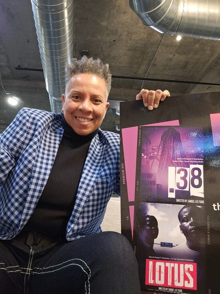 Swan Simpson holds a poster for the film Lotus, showcasing BOD TV's independent films.