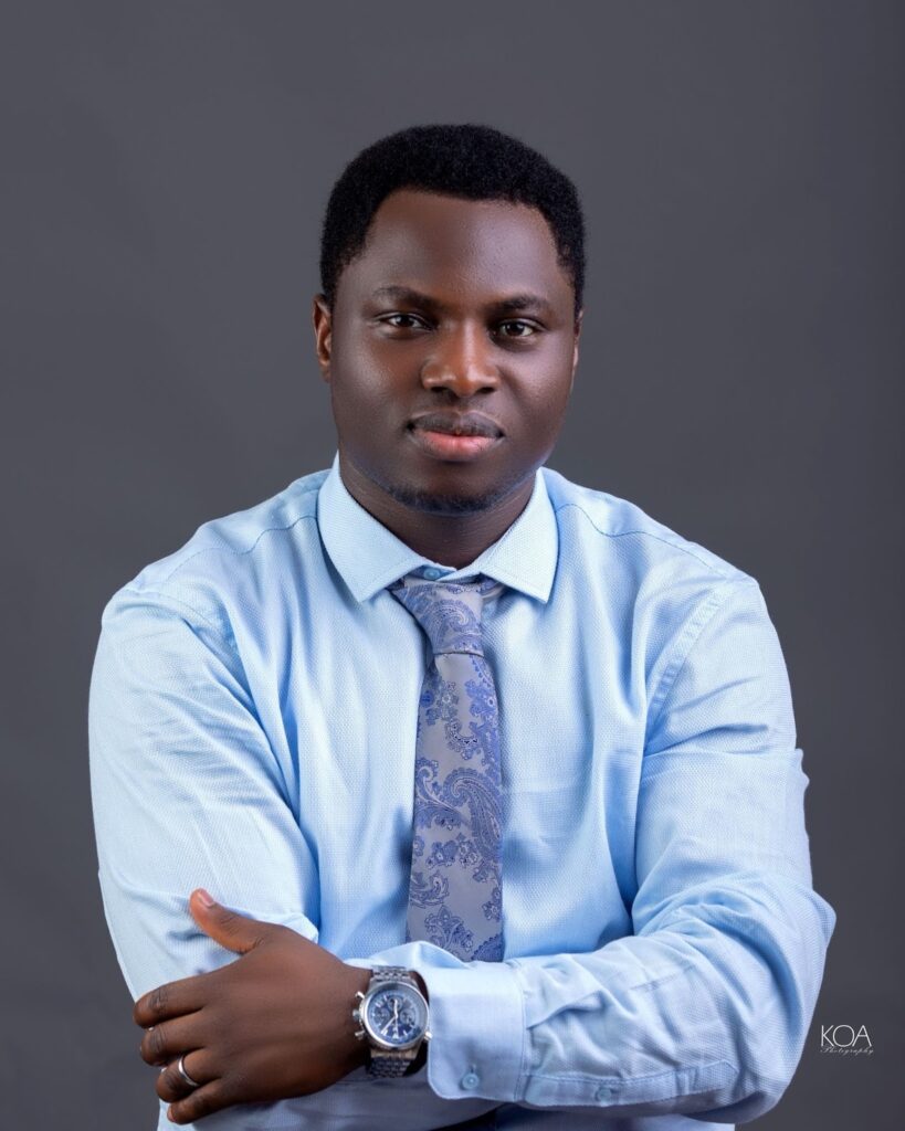 Kehinde Tomilola Boyinde in a blue shirt and tie, representing the vision of Bulbling247’s global influence.