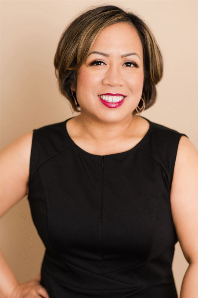 Jeanell Greene, Relationship Coach, close-up with a warm smile in a black dress.