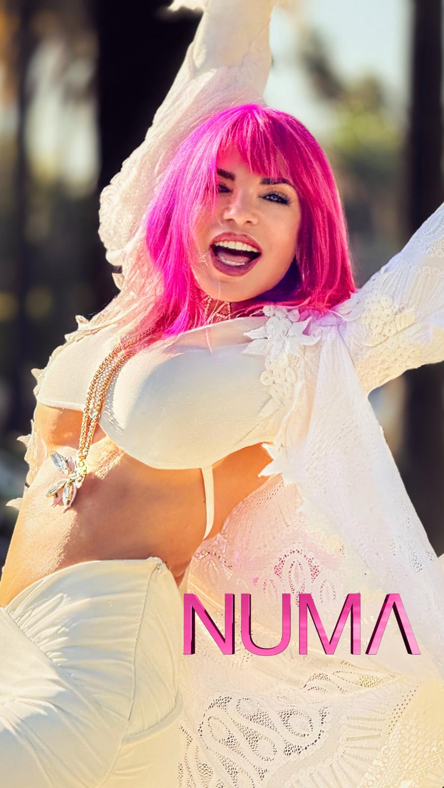 NUMA radiates joy in white attire, symbolizing self-empowerment and holistic growth.