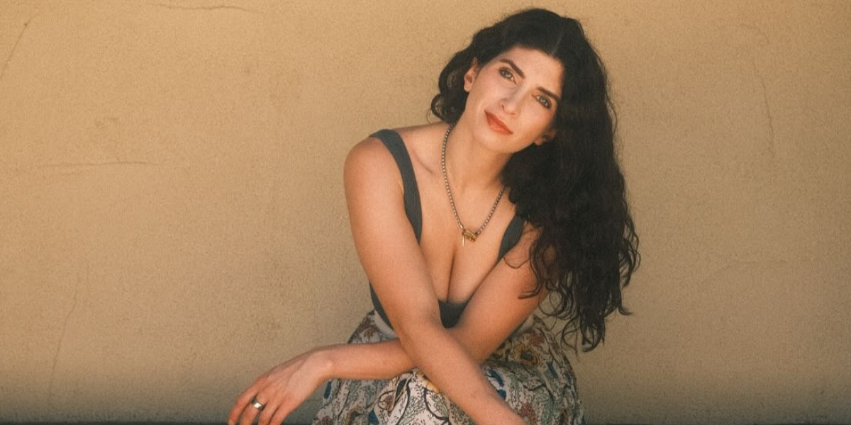 Anabelle Ciancuillo seated outdoors, offering a relaxed and reflective expression.