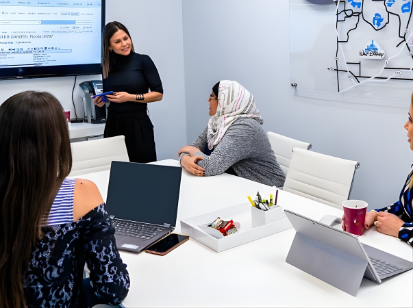 Alejandra Silva leading a meeting with a diverse group of real estate professionals.