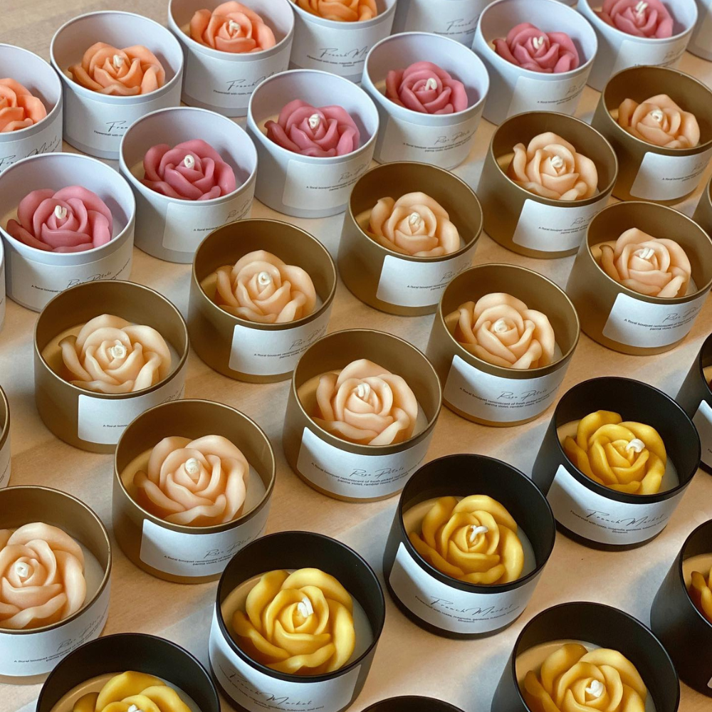 Elegant rose-shaped candles in beautiful gold and black packaging by Crazy About Candles.