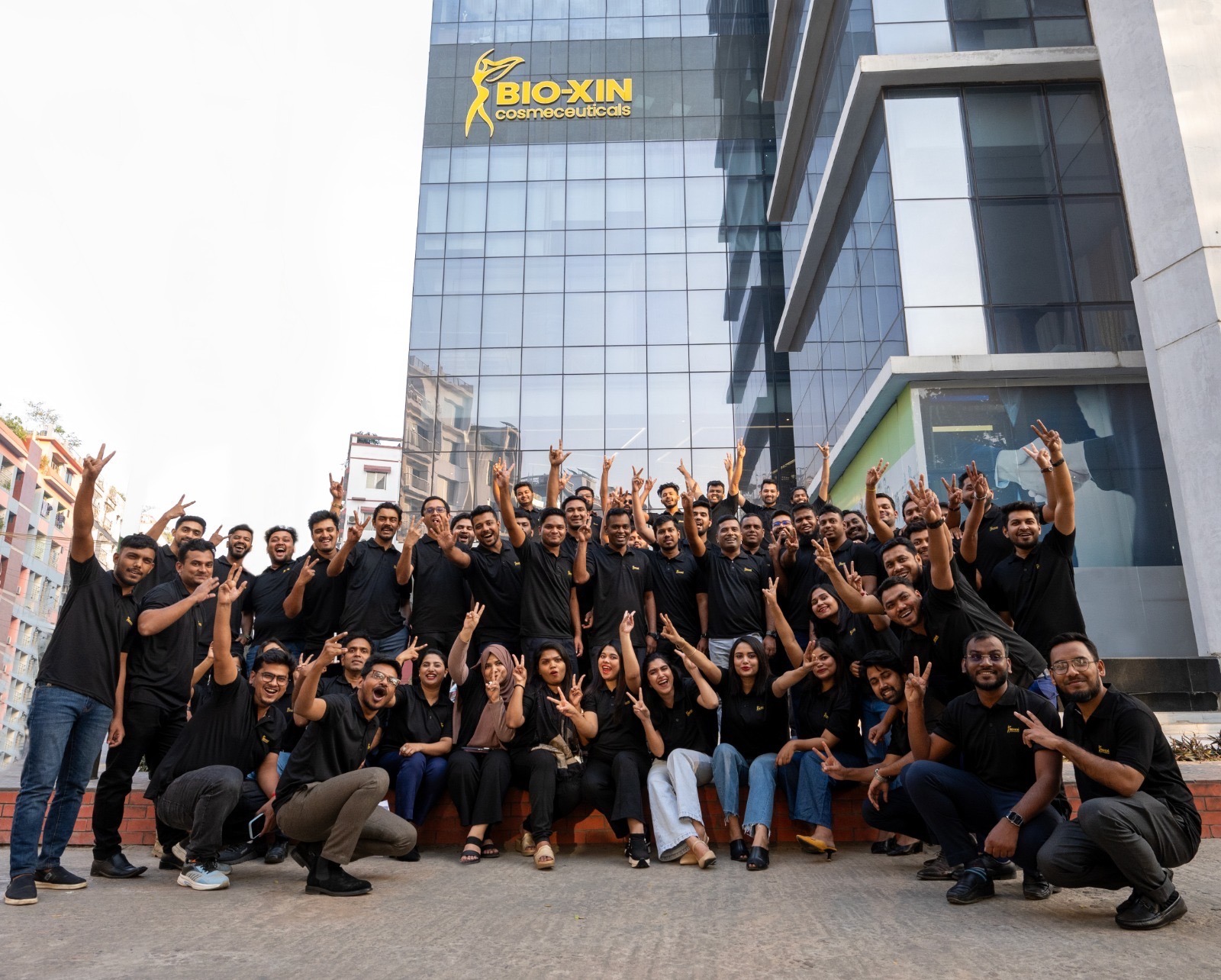 Bio-Xin team celebrating outside their headquarters in Bangladesh.