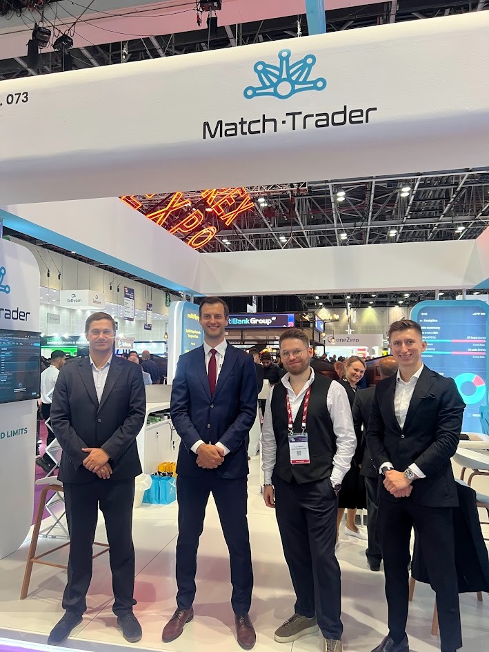 Team members at the Match.Trader booth during the event.