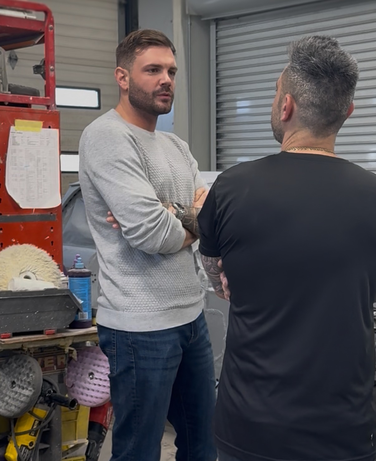 Jason Duffy engaged in a conversation with a colleague at work.