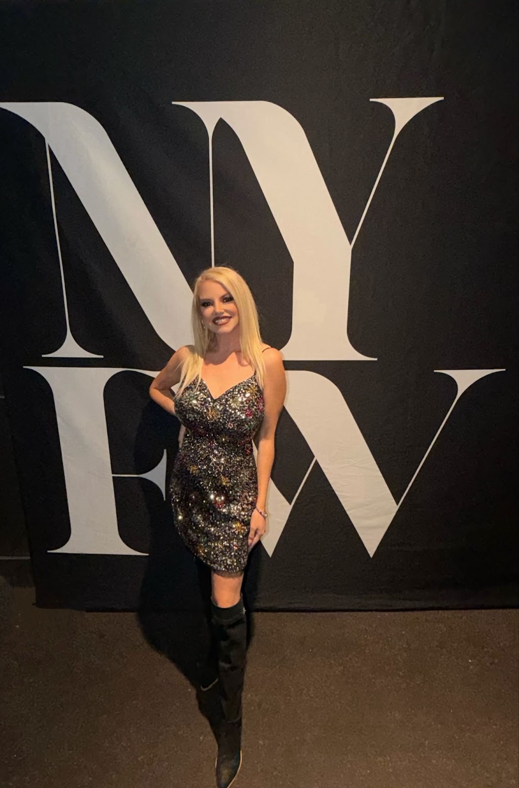 Yianina Bugani posing at New York Fashion Week with a sparkling dress.