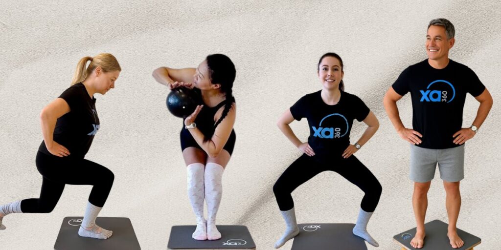 A diverse group of individuals performing various exercises on mats, showcasing FitNWell’s XA360 approach to movement and strength.
