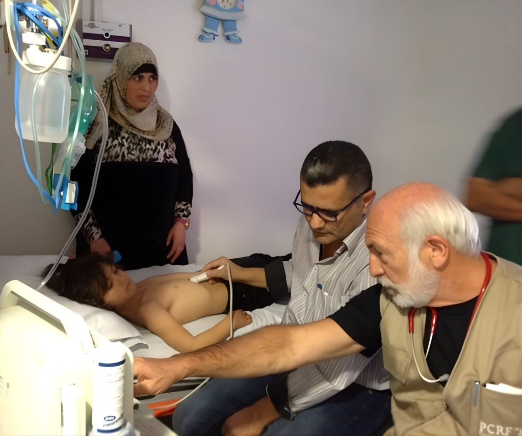 A man sits in a hospital bed, holding a child, symbolizing care and connection in a healing environment.