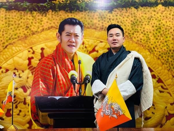 Photo wall featuring Bhutanese monarchs and cultural imagery, celebrating unity and leadership.