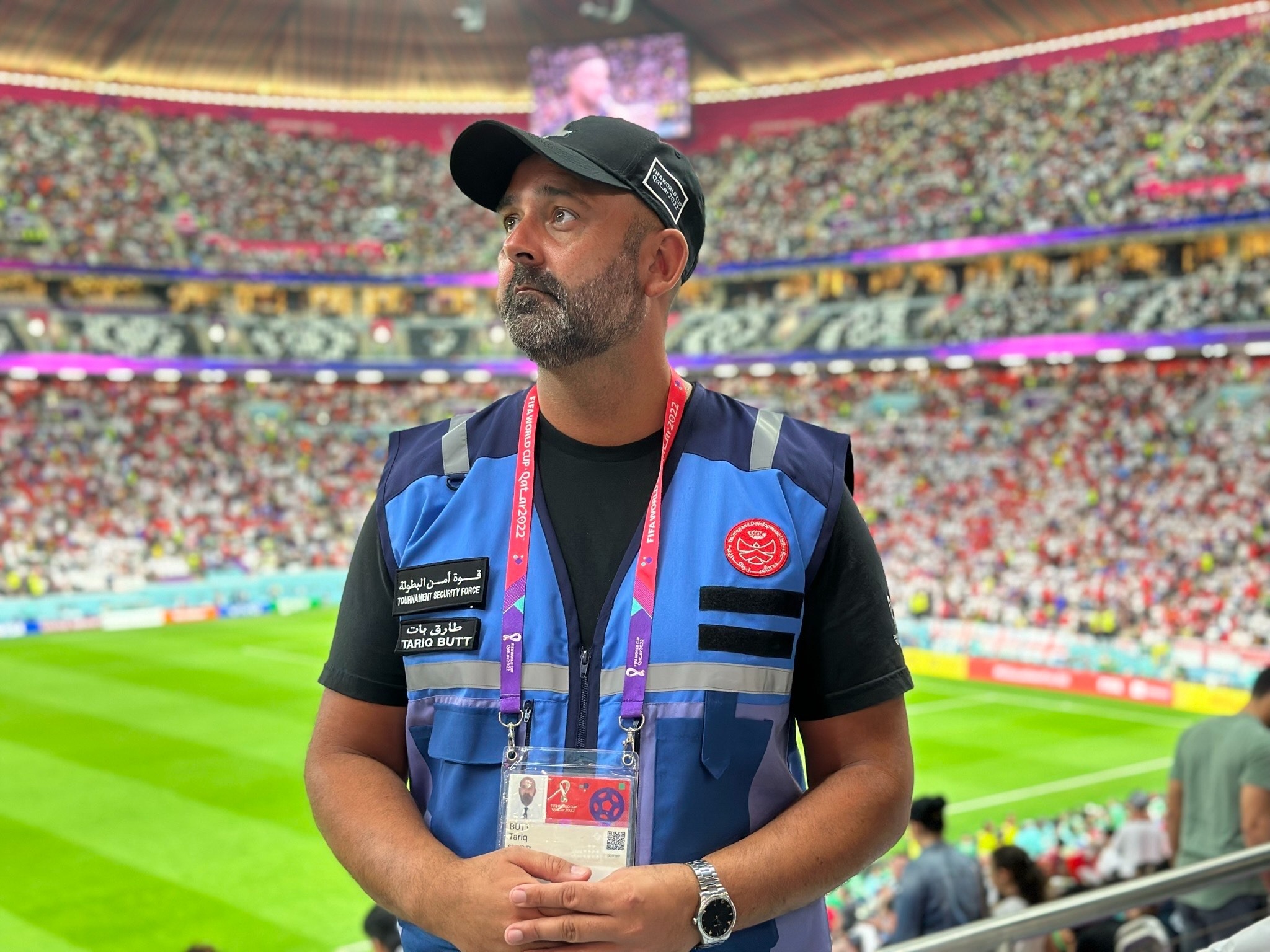 Event operations professional standing inside a packed football stadium during an international match.