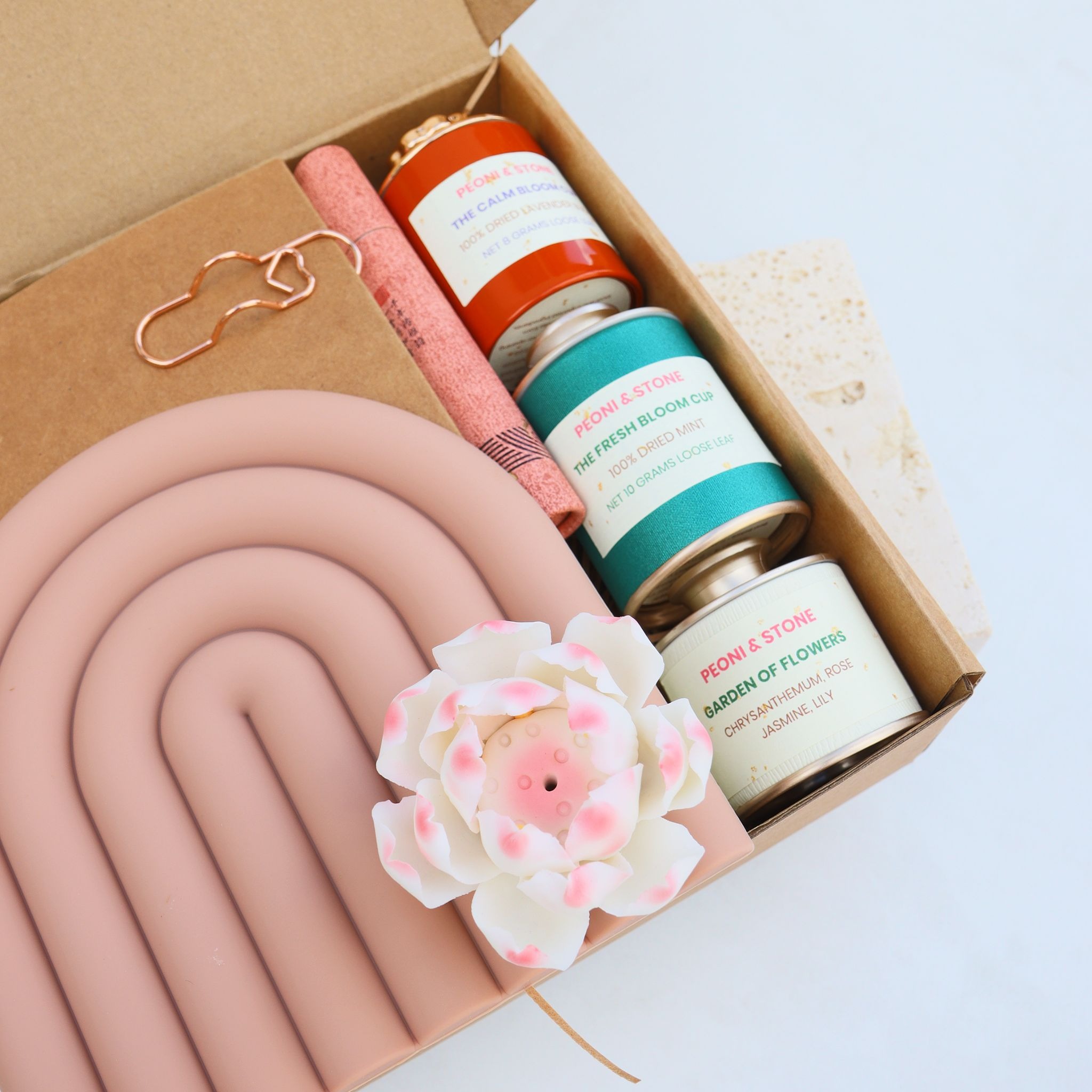 Peoni & Stone wellness gift box with incense, floral teas, journal, and ceramic holder.