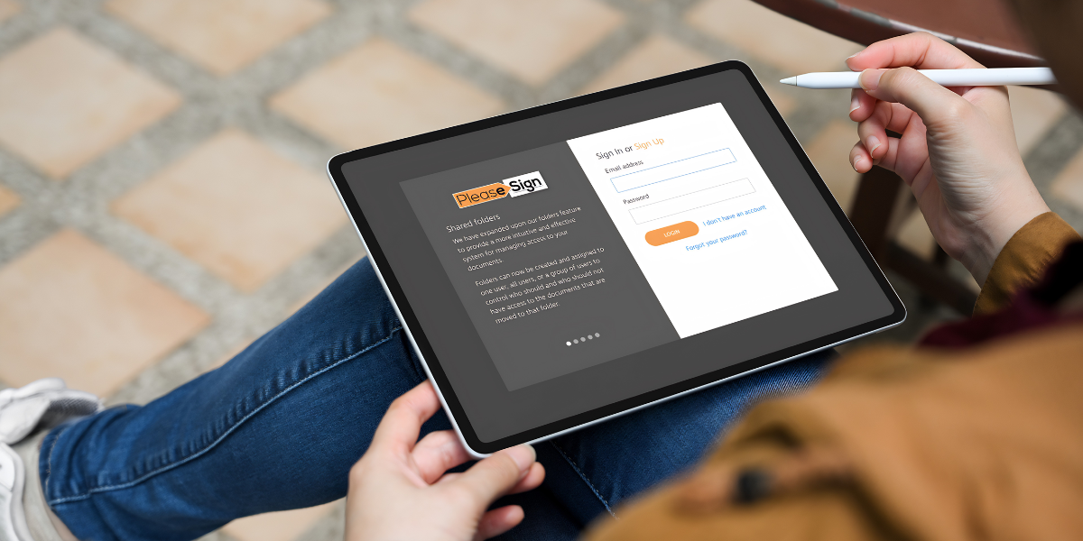 Person using tablet and stylus to access PleaseSign digital document signing login screen.