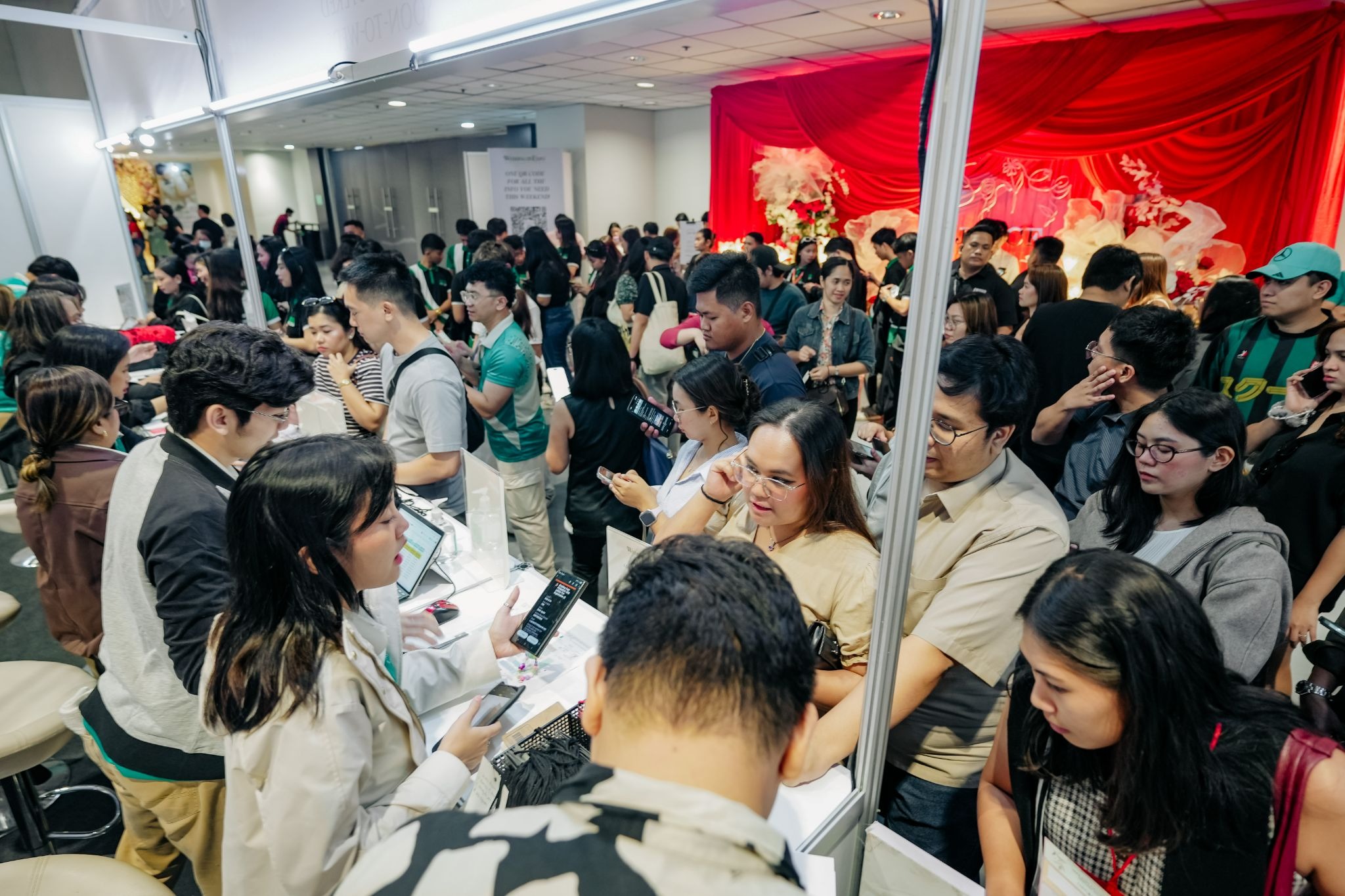 Crowds attending a busy wedding expo registration area in Manila.