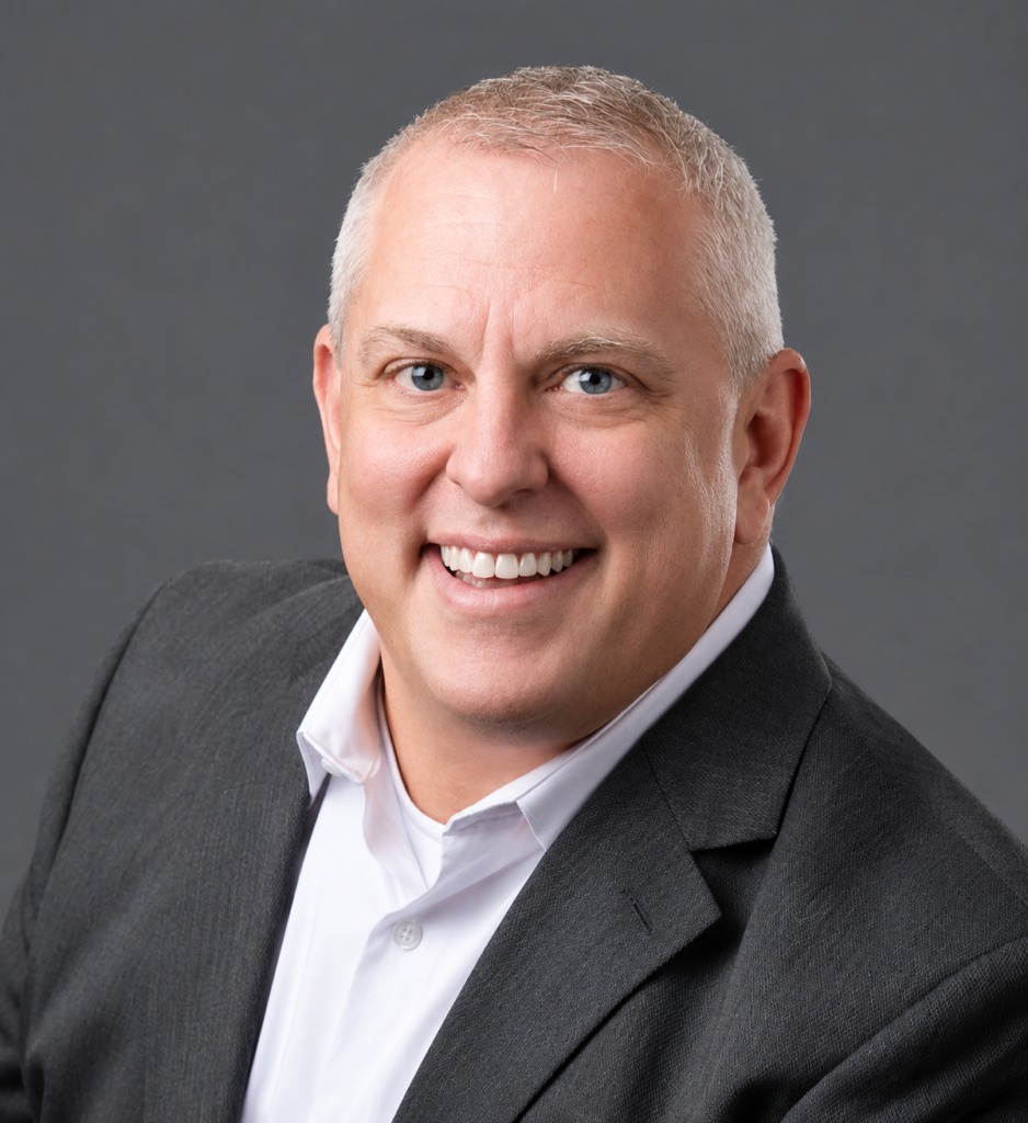 “Professional headshot of DreamStart Building Company President John Piazza Norton smiling in business attire.”