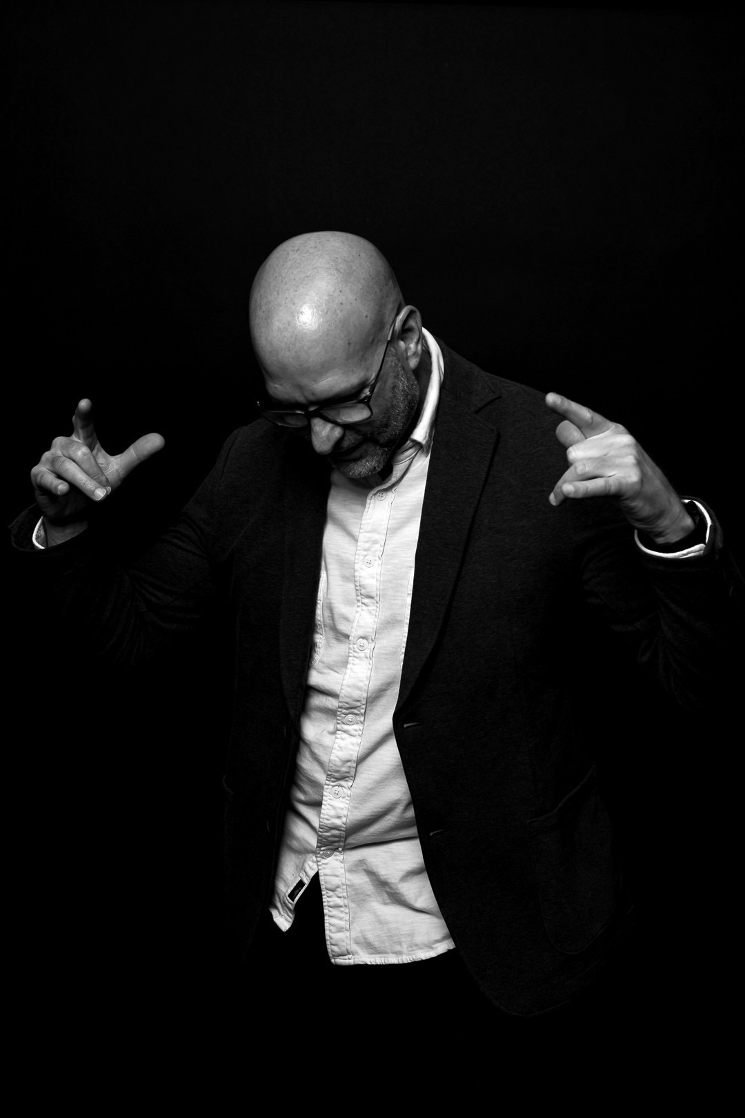 Ryan Ware gestures confidently during a black-and-white portrait, reflecting leadership and curiosity in navigating change.