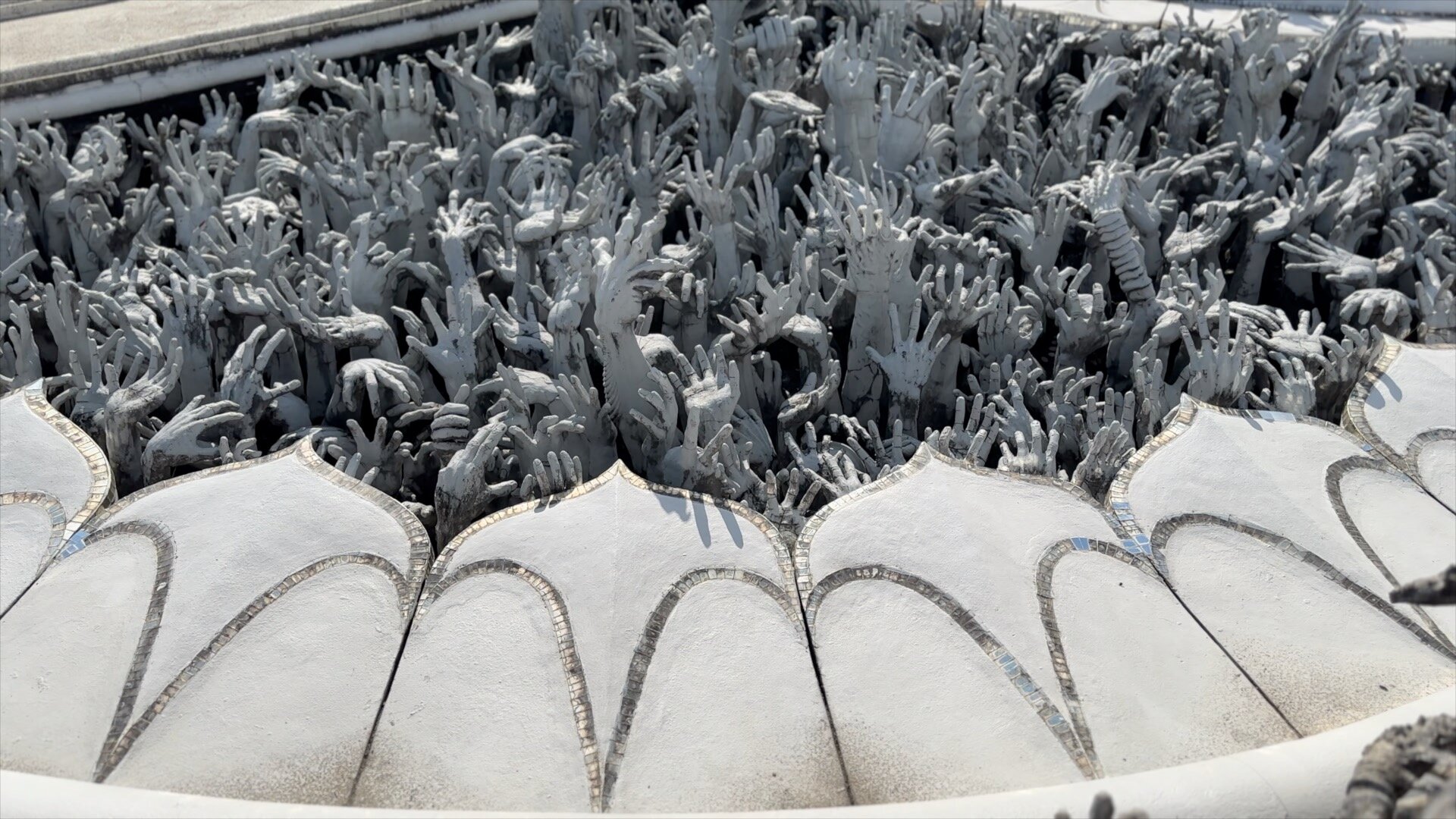 Hands reaching out from the underworld at the famous “White Temple” in northern Thailand.  