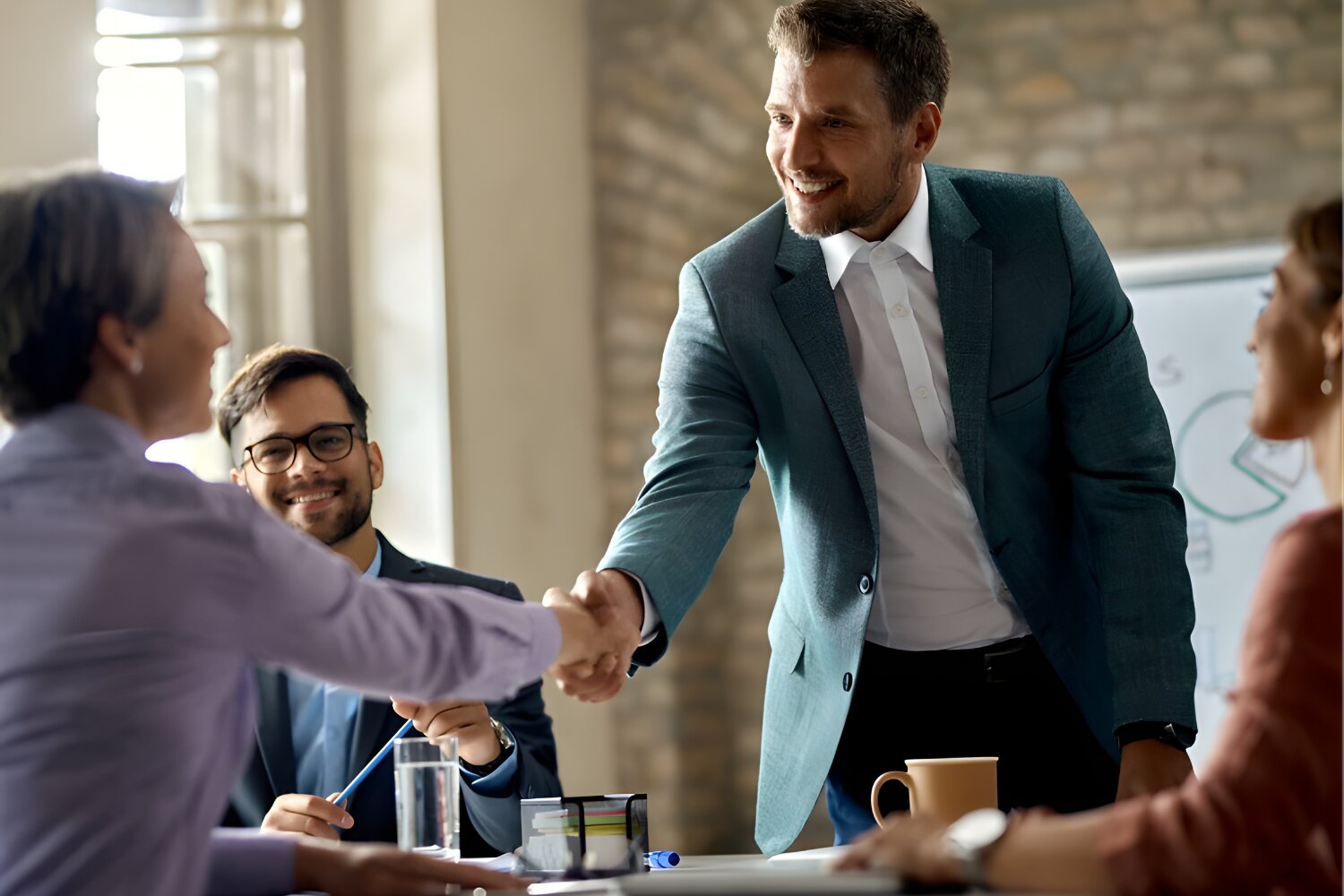 Business meeting handshake between contractor and property managers, symbolizing trust-based commercial partnerships.