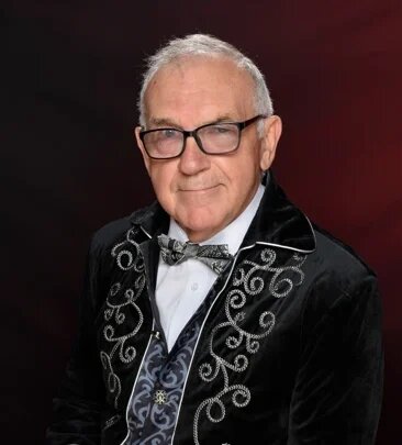 David Wortley in formal embroidered jacket, portrait highlighting technology speaker and innovation advocate.