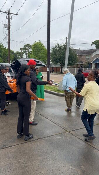 Community outreach event with Moe Vickers and volunteers engaging residents near the portable 180 Rodeo skating rink.