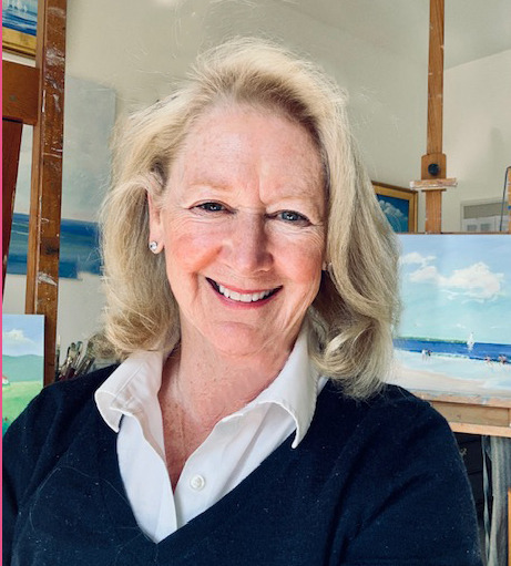 Christine Frisbee smiling in a bright home setting, wearing a red blouse and glasses.