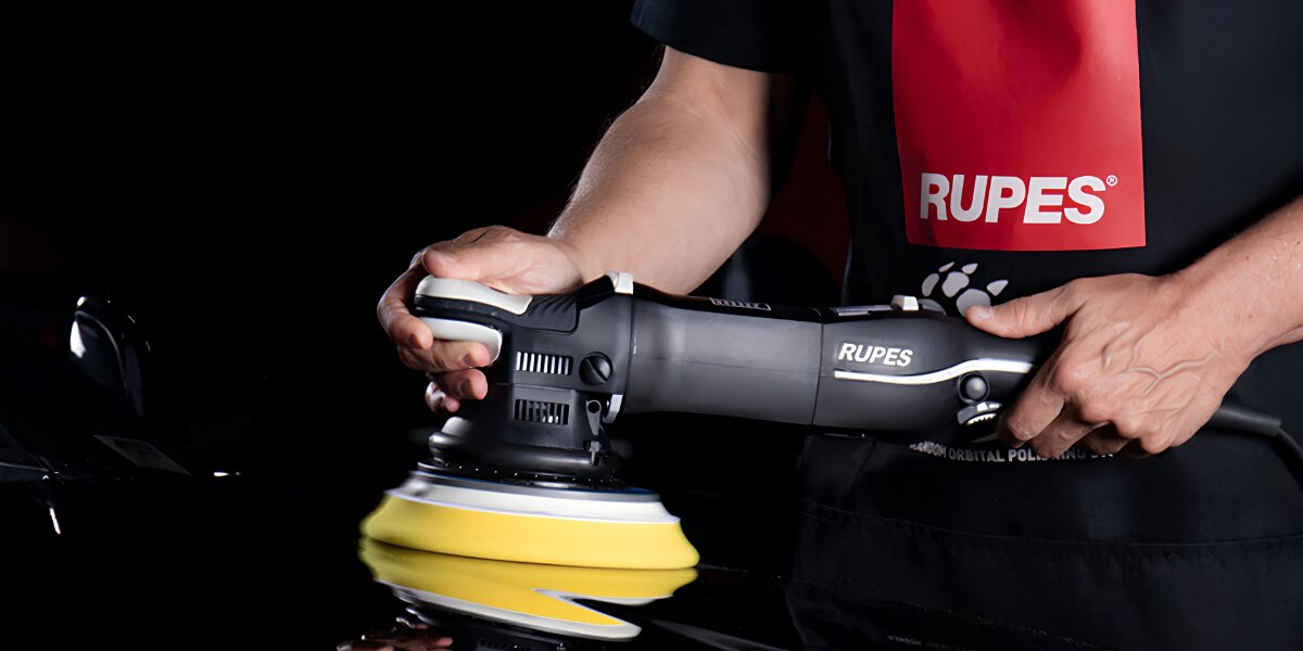 Professional using orbital polisher to finish and polish automotive paint surface