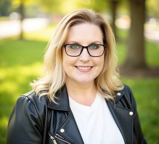Dr. Angela Solic smiling outdoors, founder of The Still I Heal Project and childhood trauma educator.