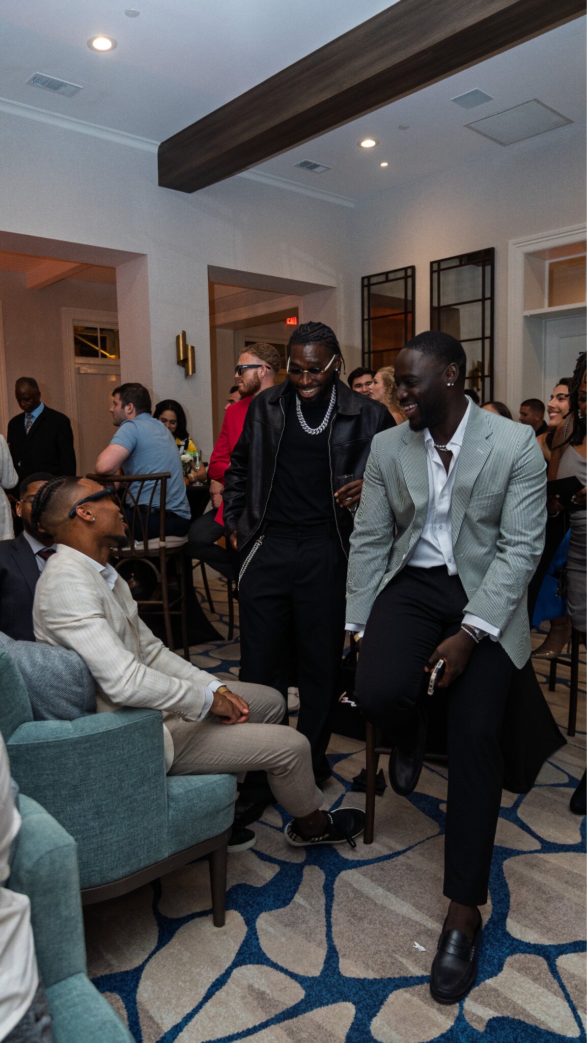 Guests mingle and converse during JCI exhibition launch, celebrating creativity, fashion, and community.