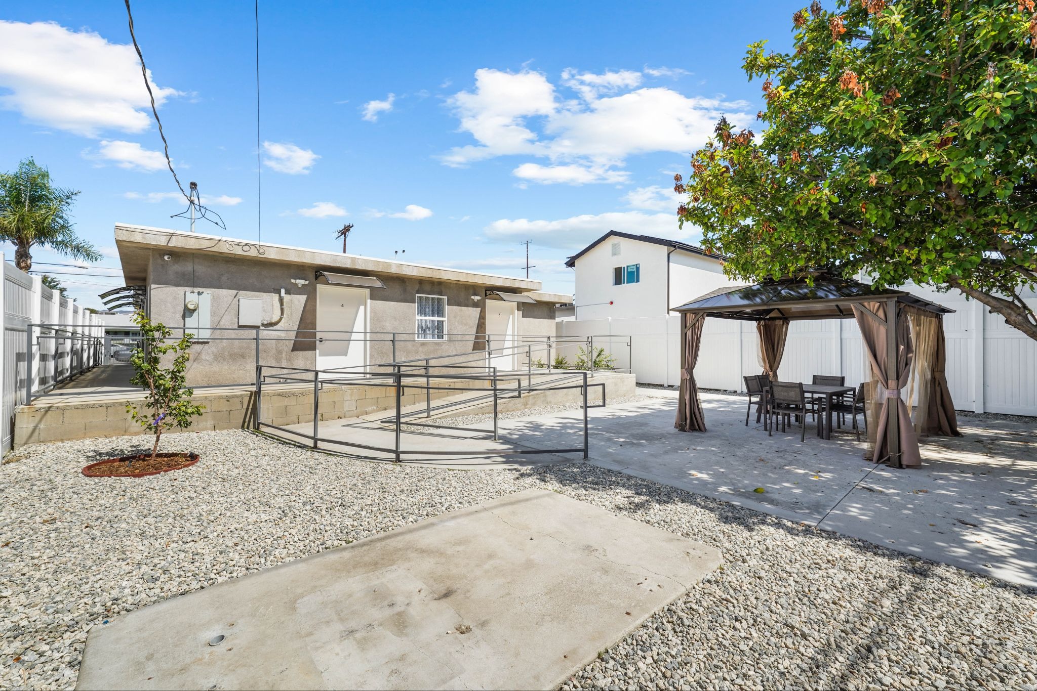 Accessible outdoor courtyard with shaded gazebo seating for residents to relax and socialize.