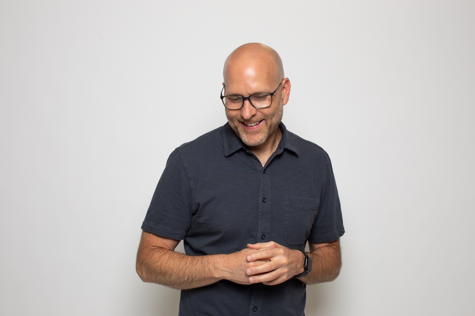 Ryan Ware smiling in a casual portrait, founder of Connective Consulting Group and advocate for curiosity-driven leadership.