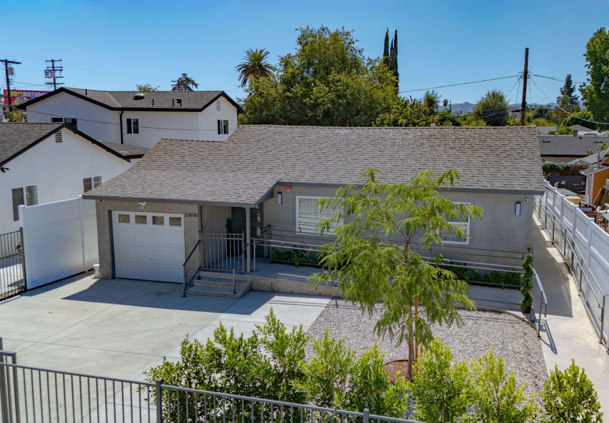 Front view of Home & Heart Residential Care residence with accessible entrance and landscaped grounds.