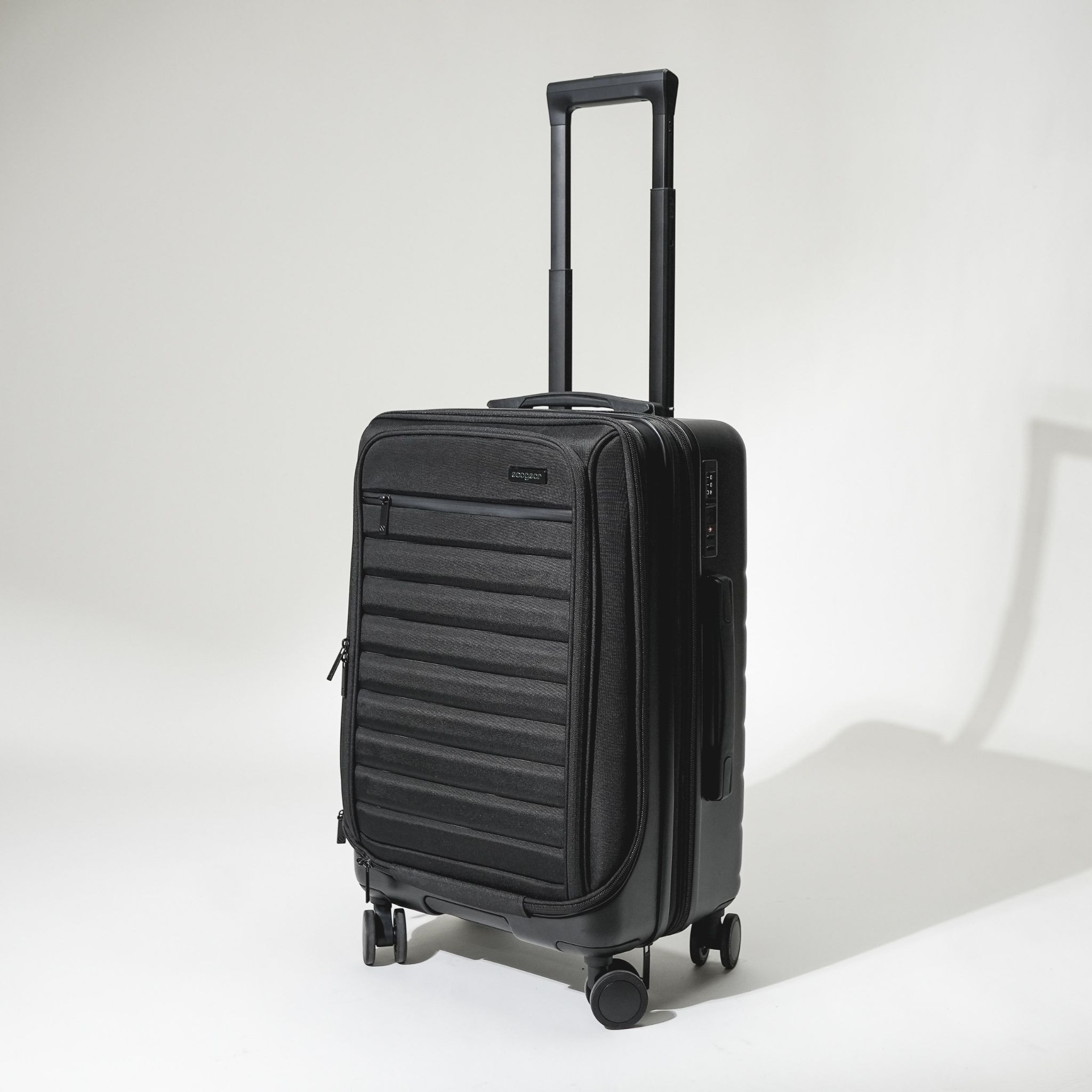 Black Ecogear Hybrid Carry-On with telescoping handle, front organizer pocket, and spinner wheels on a white background.