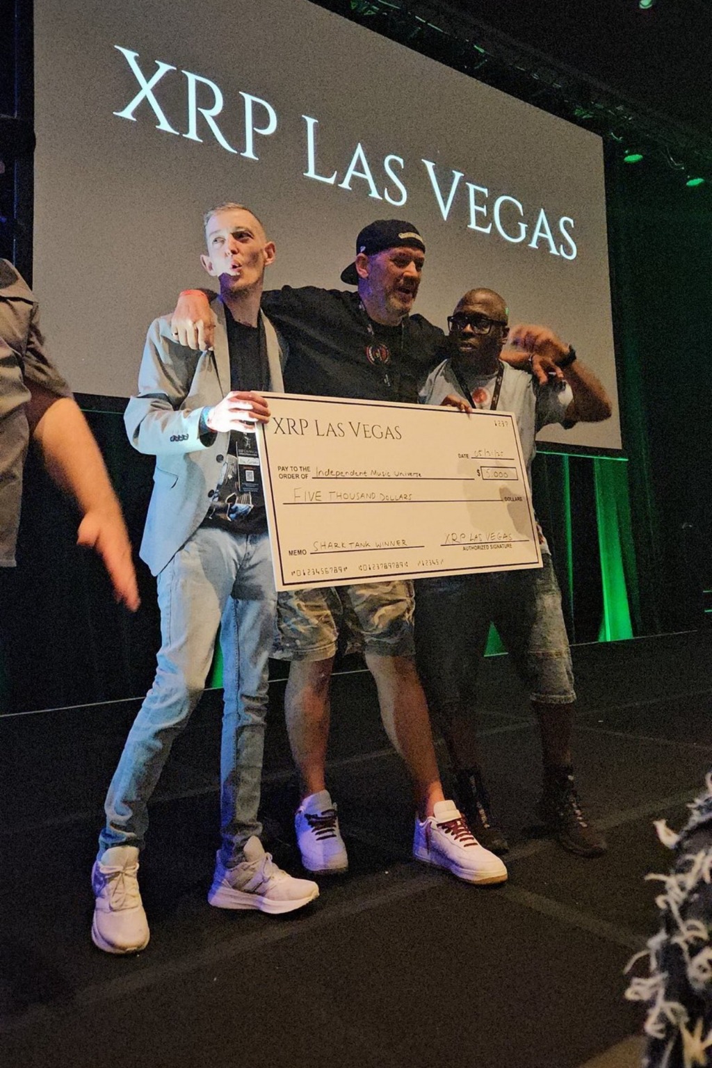 IMU founders celebrate winning the XRP Las Vegas Shark Tank competition with a $5,000 prize check.