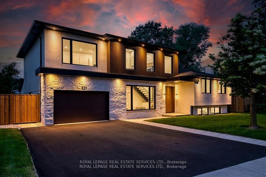 Contemporary Burlington home illuminated at dusk with warm exterior lighting and modern design